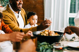 Father Holding Baby at the Thanksgiving Table  image 2