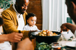 Father Holding Baby at the Thanksgiving Table  image 1