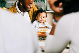 Father Holding Baby at the Thanksgiving Table  image 1