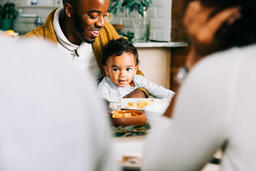 Father Holding Baby at the Thanksgiving Table  image 2