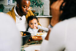 Father Holding Baby at the Thanksgiving Table  image 3