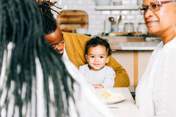 Father and Baby Interacting While Seated at the Thanksgiving Table  image 1
