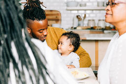 Father and Baby Interacting While Seated at the Thanksgiving Table  image 2