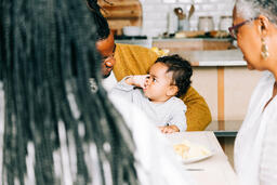 Father and Baby Interacting While Seated at the Thanksgiving Table  image 3