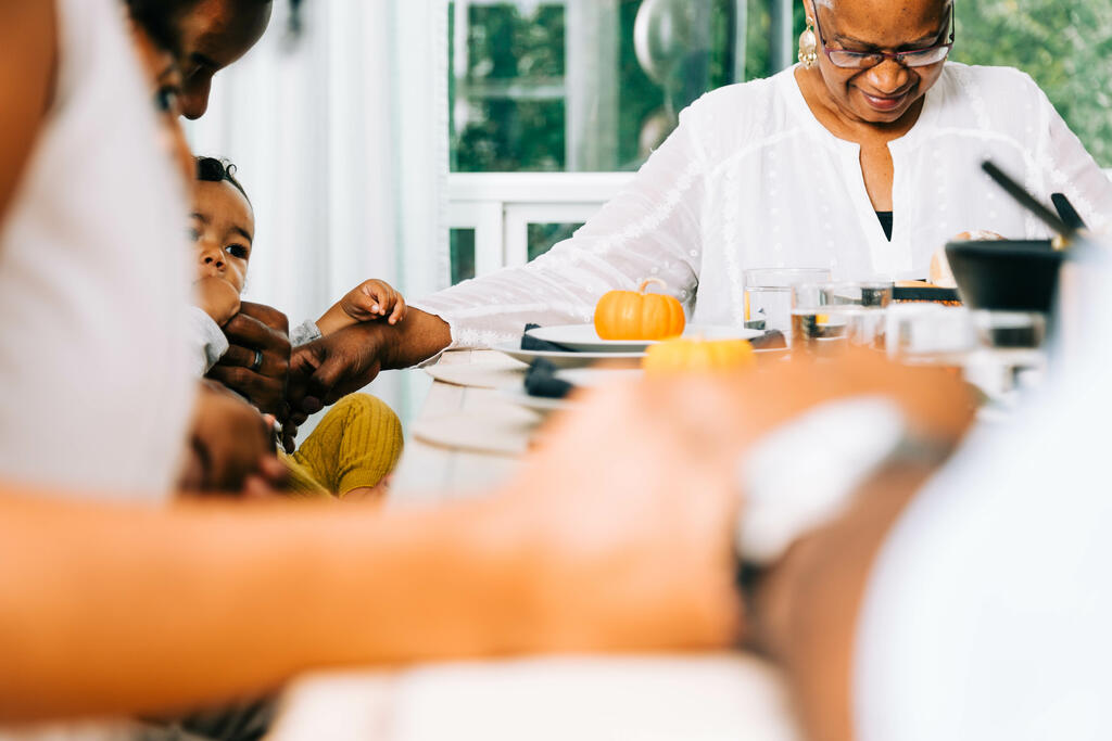 Family Praying Together Before the Thanksgiving Meal large preview