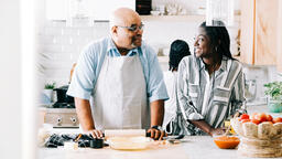 Father and Daughter Laughing Together While Preparing the Thanksgiving Meal  image 1