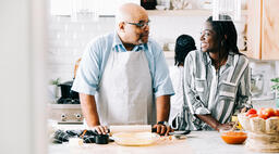 Father and Daughter Laughing Together While Preparing the Thanksgiving Meal  image 3