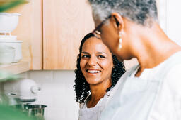 Mother and Daughter Laughing Together in the Kitchen  image 3