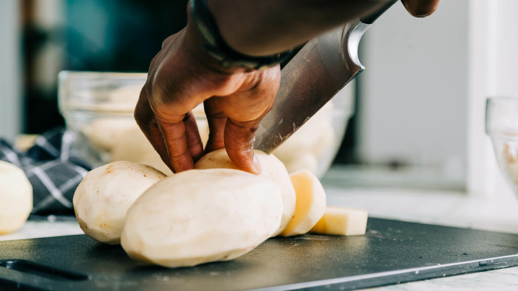 Man Chopping Potatoes large preview
