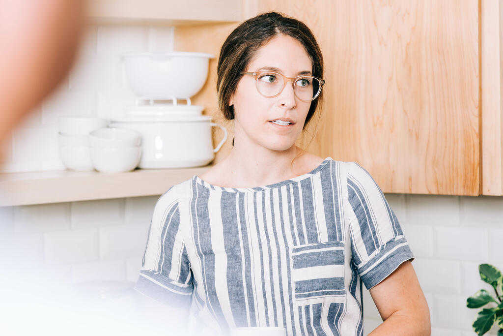 Woman Holding Cup of Coffee and having Conversation in the Kitchen large preview