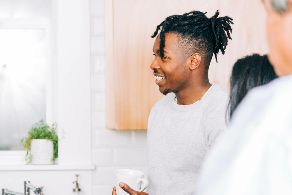 Man Holding Cup of Coffee and Having Conversation in the Kitchen large preview