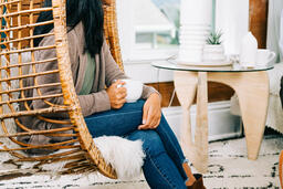 Woman Holding Cup of Coffee and Engaging in Conversation at Small Group  image 1