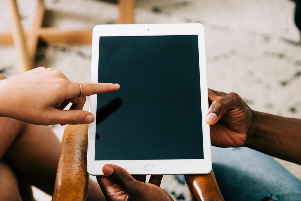 Woman Pointing at Man's iPad Screen large preview