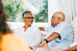 Married Couple Laughing with Each Other at Small Group  image 4