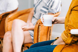Woman Holding a Cup of Coffee during Small Group  image 1