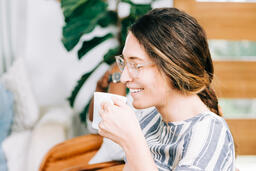 Woman Holding Coffee Cup and Laughing during Small Group  image 2