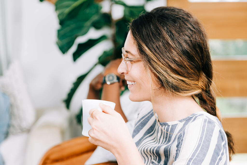 Woman Holding Coffee Cup and Laughing during Small Group large preview