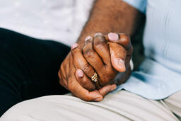 Two Small Group Members Holding Hands in Prayer  image 1