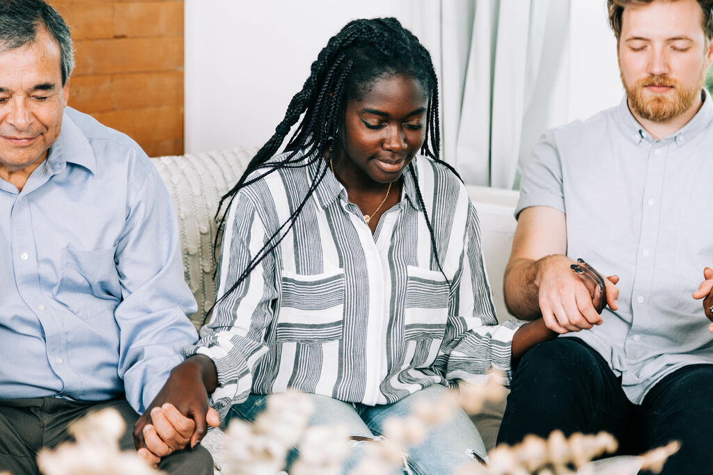 Small Group Members Holding Hands in Prayer large preview