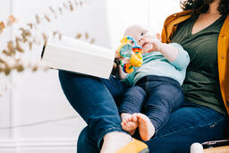 Woman Holding Baby and Open Bible  image 2
