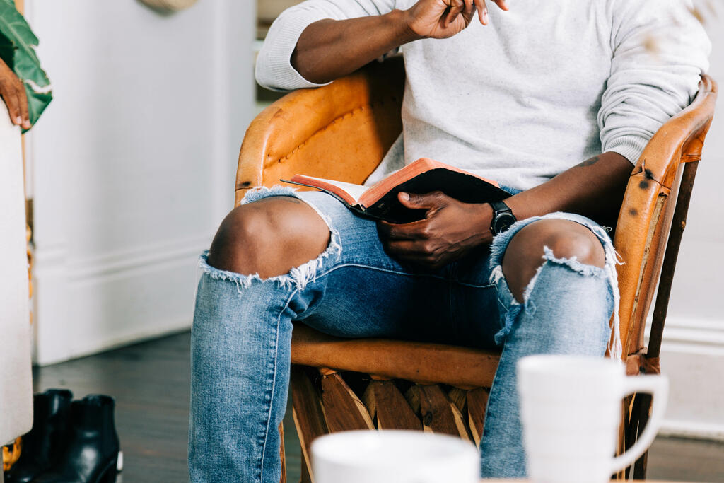 Man Holding Open Bible at Small Group large preview