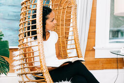 Woman in Hanging Chair with Open Bible on her Lap  image 1