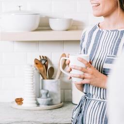 Woman Holding Cup of Coffee and having Conversation in the Kitchen  image 3