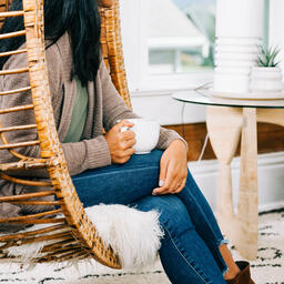 Woman Holding Cup of Coffee and Engaging in Conversation at Small Group  image 2