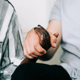 Two Small Group Members Holding Hands in Prayer  image 2