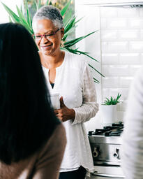 Woman Laughing in Conversation in the Kitchen  image 4