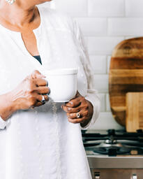 Woman Holding Cup of Coffee in the Kitchen  image 3
