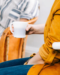 Woman Holding a Cup of Coffee during Small Group  image 3