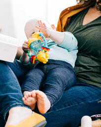 Woman Holding Baby and Open Bible  image 4