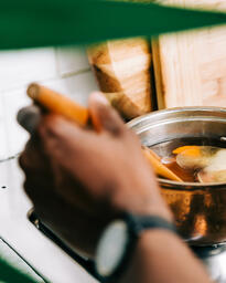 Man Stirring Apple Cider on Stovetop  image 3