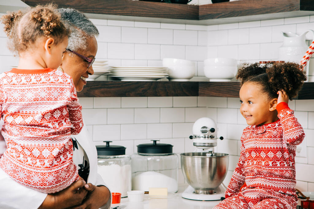 Woman Baking Christmas Cookies with her Grandchildren large preview