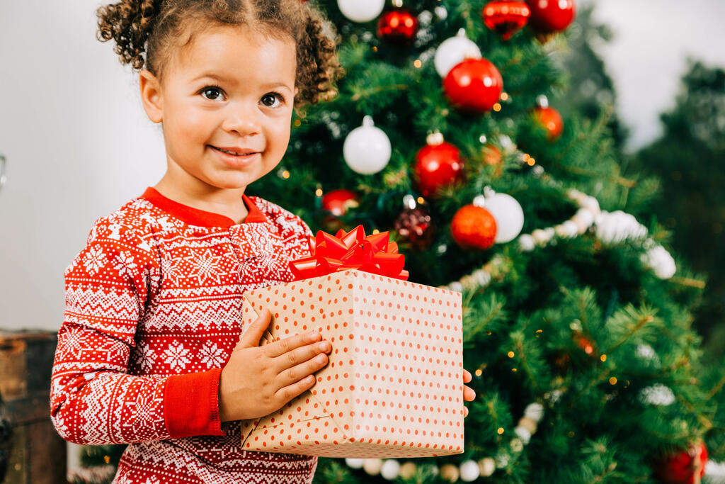 Child Holding a Christmas Present large preview