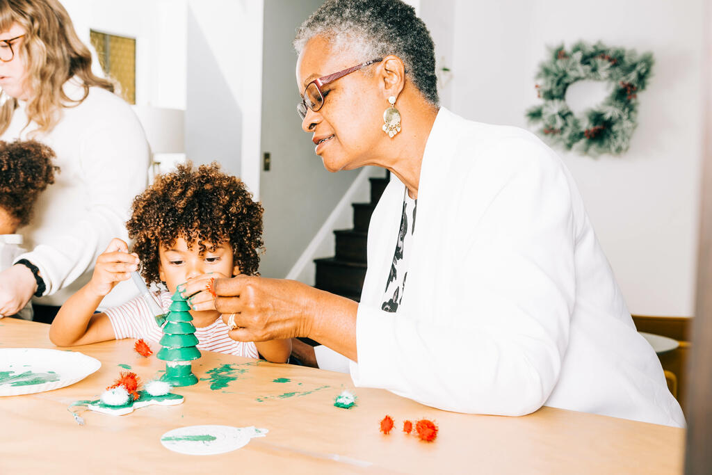 Grandmother and Grandson Doing a Christmas Craft Together large preview