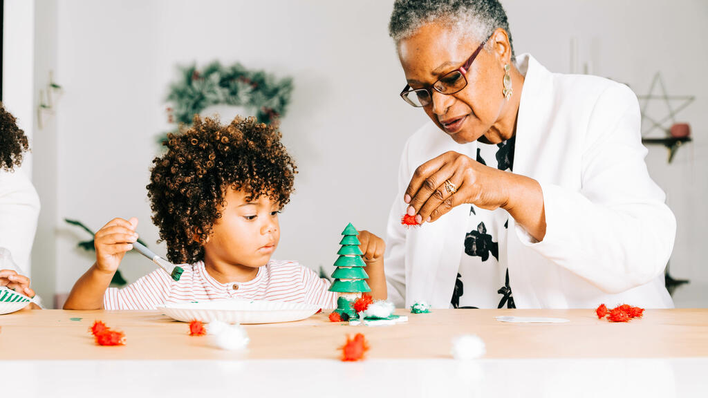 Grandmother and Grandson Doing a Christmas Craft Together large preview