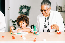 Grandmother and Grandson Doing a Christmas Craft Together  image 2