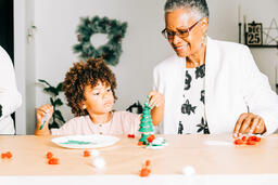 Grandmother and Grandson Doing a Christmas Craft Together  image 3