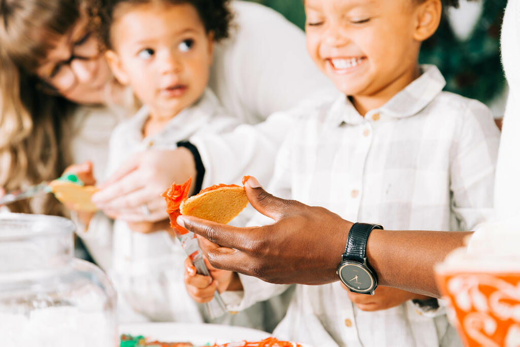 Family Frosting Christmas Cookies Together large preview