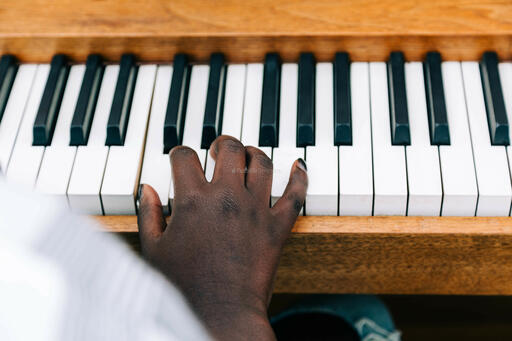 Woman's Hand on Keys of Piano