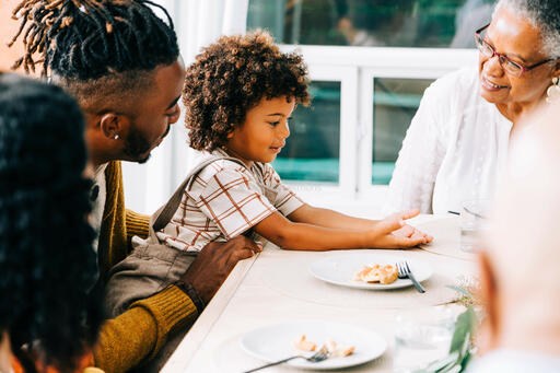 Grandmother Laughing with Grandchild at the Thanksgiving Table