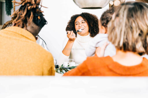 Family Laughing Together at the Thanksgiving Table