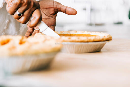 Woman Slicing Pumpkin Pie