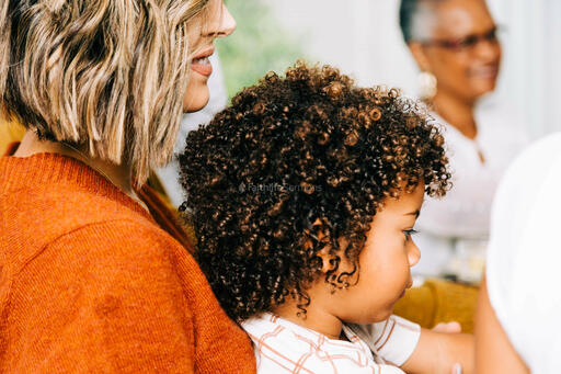 Child Seated on Mother's Lap at the Thanksgiving Table
