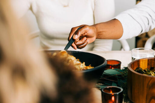 Man Serving Stuffing at the Thanksgiving Table