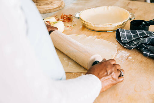 Woman Rolling Out Crust for Apple Pie