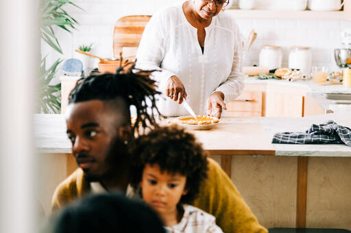 Grandmother Slicing and Serving Pie in the Kitchen