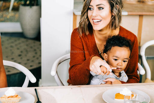 Baby Seated in Mother's Lap, Enjoying Pumpkin Pie